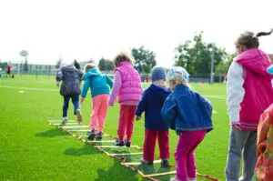 young school age children participate in a sport together