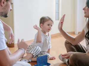 a little child in between two parents playing