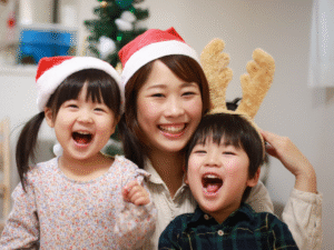 A young family with a mother wearing Christmas hats
